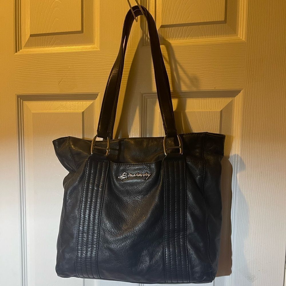 B Makowsky leather black medium shoulder bag with silver tone hardwares.